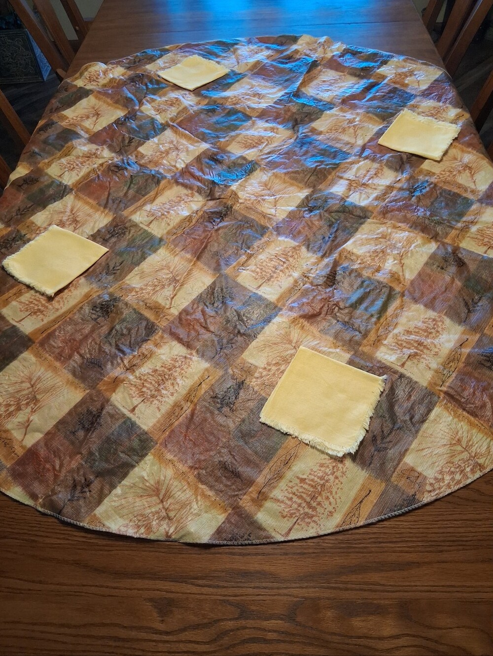 Round 60" earthy-toned patchwork quilt design vinyl tablecloth & napkins